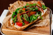Prosciutto and salad ciabatta sandwich, closeup view — Stock Photo