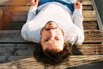 Overhead view of a man sitting on wooden steps — Stock Photo