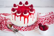 Sponge cake with raspberries, cream with raspberry coulis — Stock Photo