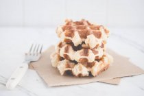 Stack of Belgian waffles on napkins, closeup view — Stock Photo