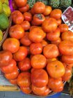 Close-up shot of pile of persimmon fruits selling on market — Stock Photo