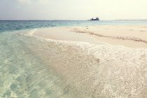 Живописный вид на тропический пляж с кораблем вдали, Мальдивы — стоковое фото