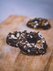 Chocolate cookies with nuts on wooden board — Stock Photo