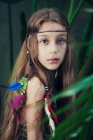 Portrait of a girl wearing a bohemian feather headdress — Stock Photo
