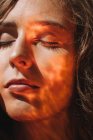 Nahaufnahme Porträt einer Frau mit Licht, das ihr Gesicht reflektiert — Stockfoto