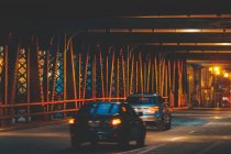 Autos fahren nachts unter Hochbahngleisen und Brücke über den Fluss Chicago, illinois, United States — Stockfoto