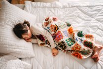 Adorable young girl sleeping on bed — Stock Photo