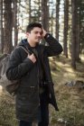 Mann steht mit Rucksack im Wald — Stockfoto