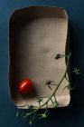 Cherry tomato and a vine in a box, top view — Stock Photo