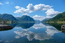 Scenic view of rural landscape reflecting in water, Norway — Stock Photo