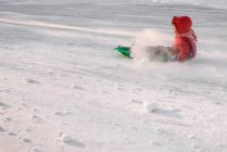 Junge rodeln in der Natur im Schnee — Stockfoto