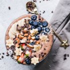 Chocolate smoothie bowl with fresh fruit and nuts — Stock Photo