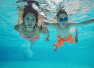 Mãe e filho nadando debaixo de água em uma piscina — Fotografia de Stock