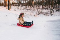 Boy sledging down a hill — Stock Photo