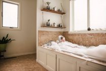Мальчик, сидящий в ванне с пеной — стоковое фото