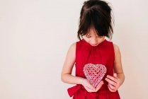 Girl holding a heart shape decoration — Stock Photo