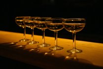 Closeup view of row of champagne coupe glasses — Stock Photo