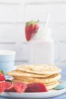 Stack of pancakes with fresh strawberries, closeup view — Stock Photo