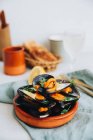 Steamed mussels with lemon and toast, closeup view — Stock Photo