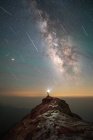 Homem com tocha na cabeça no chuveiro do meteoro, céu da noite da maneira leitosa — Fotografia de Stock