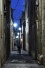 People walking down the street at night, Zejtun village, Malta — Stock Photo
