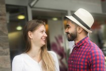 Couple standing in front of a shop talking — Stock Photo