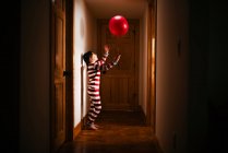 Fille debout dans le couloir jouer avec une boule géante — Photo de stock