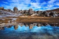 Vista panorâmica das reflexões de Rock em uma poça de água, Castle Hill, South Island, Nova Zelândia — Fotografia de Stock