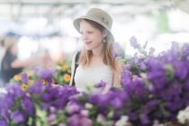 Woman buying flowers at a market — Stock Photo