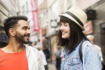 Portrait of a smiling couple in a city street shopping — Stock Photo