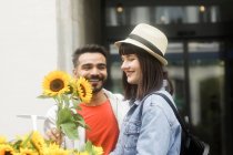 Couple debout dans la rue faisant du shopping pour les fleurs — Photo de stock