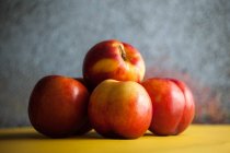Stack of nectarines on plate, closeup view — Stock Photo