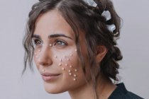 Portrait of a smiling woman with pearls on her face — Stock Photo