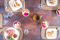 Overhead view of breakfast over wooden table — Stock Photo