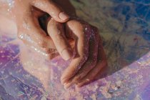 Primo piano vista delle mani femminili ricoperte di glitter — Foto stock