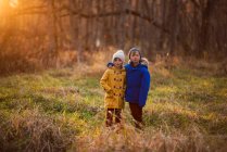 Портрет мальчика и девочки, стоящих в лесу обнимающихся, США — стоковое фото