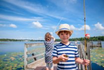 Two children fishing on a dock in the summer, United States — Stock Photo