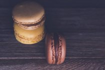 Trois macarons au chocolat et café sur une table — Photo de stock