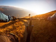 Personal perspective shot of a man mountain biking with a friend in the Alps, Gastein, Salzburg, Austria — Stock Photo
