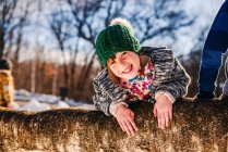 Portrait of a smiling girl climbing a tree, United States — Stock Photo