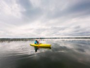 Senior woman kayaking on a lake, United States — Stock Photo