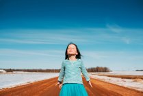 Retrato de uma menina de pé na estrada com os olhos fechados, Estados Unidos — Fotografia de Stock