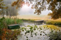 Boat moored on a river in the mist, France — Stock Photo