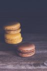 Three chocolate and coffee macaroons on a table — Stock Photo