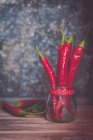 Spicy red chili peppers in a glass jar — Stock Photo