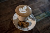 Cup of Piccolo latte with a Biscotti biscuit — Stock Photo
