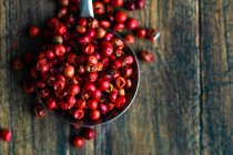 Red cranberries in a bowl on a wooden background. — Stock Photo