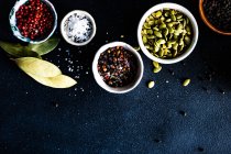 Spices and herbs on black background — Stock Photo