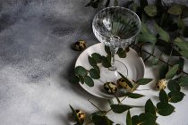 Easter table setting with Easter eggs and eucalyptus stems — Stock Photo