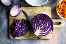 Fresh carrot, cabbage and red onions on a chopping board — Stock Photo